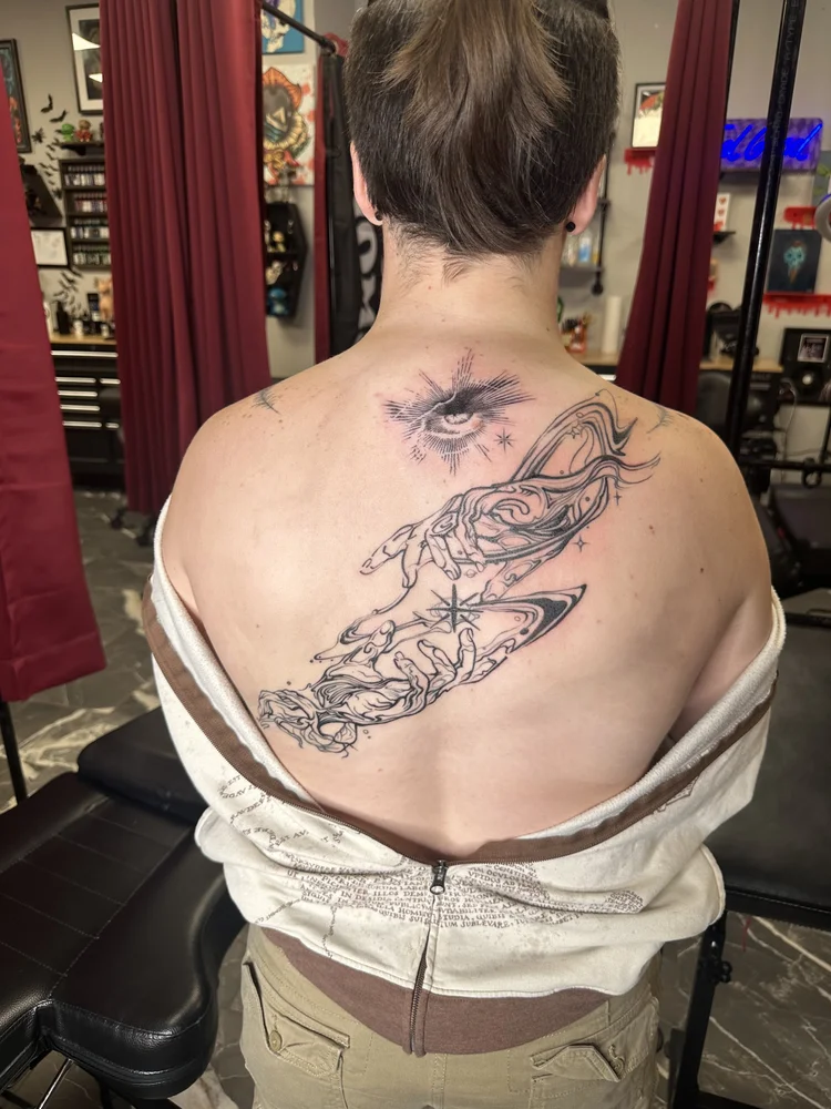 Eye and reaching hands back piece