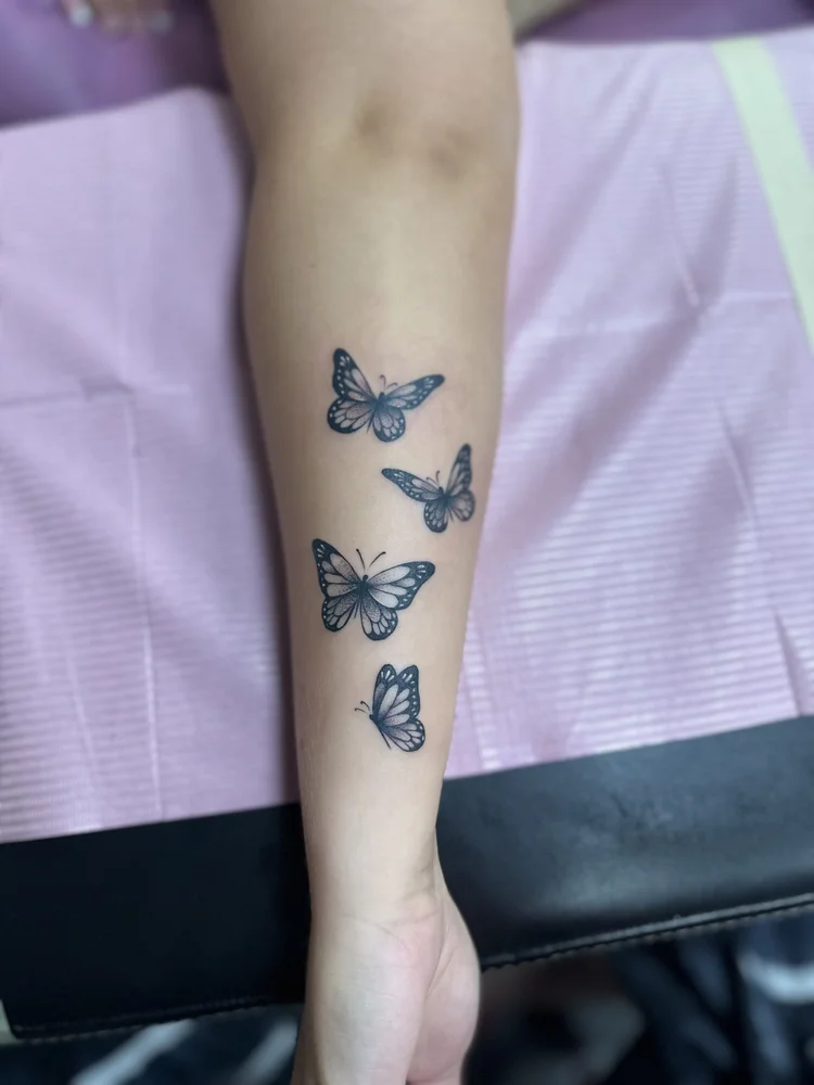 Fine line butterflies tattoo